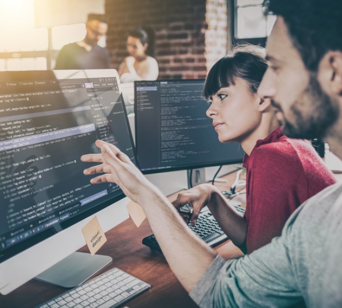 Two workers looking at a computer screen