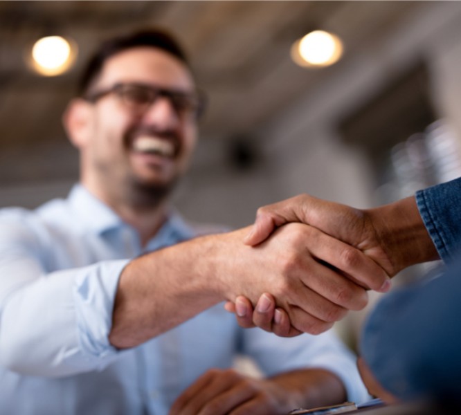 To workers sharing a handshake